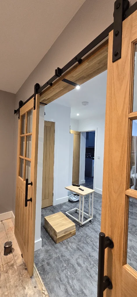 Oak sliding barn doors and hallway renovation by CIN Construction